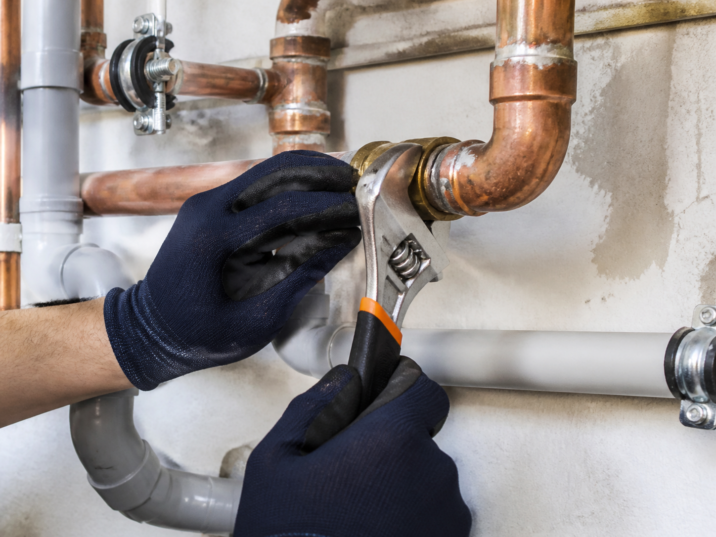 Plumber repairing copper and PVC pipes